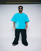 ALL WE NEED IS MONEY — AQUA WASH OVERSIZED TEE